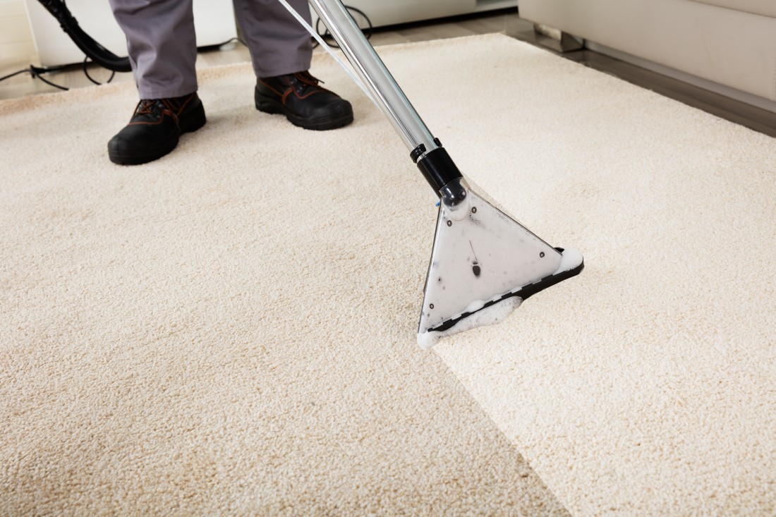 A man cleaning a carpet