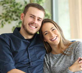 man and woman sitting together smiling